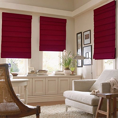 living room in Dubai with elegant red Roman blinds