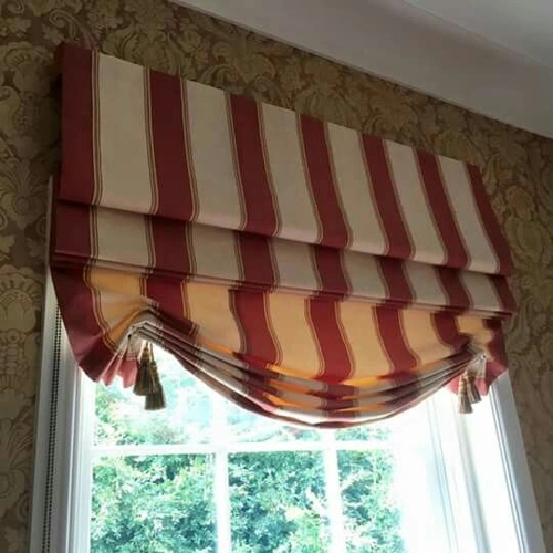 Close-up of a London or Swag style Roman blind with thick vertical stripes